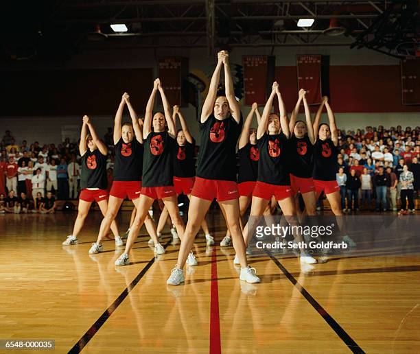 cheerleaders performing - cheerleading stock-fotos und bilder