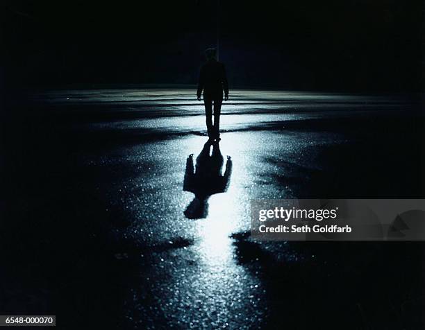 silhouetted person at night - ominous stock-fotos und bilder