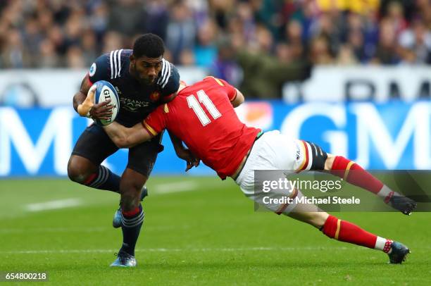 Noa Nakaitaci of France is tackled by Liam Williams of Wales during the RBS Six Nations match between France and Wales at the Stade de France on...