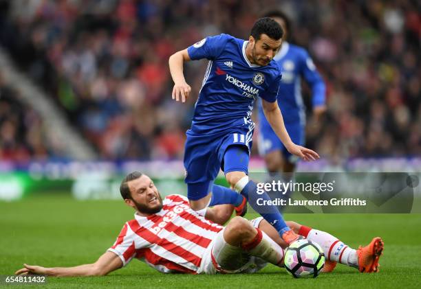 Erik Pieters of Stoke City tackles Pedro of Chelsea during the Premier League match between Stoke City and Chelsea at Bet365 Stadium on March 18,...