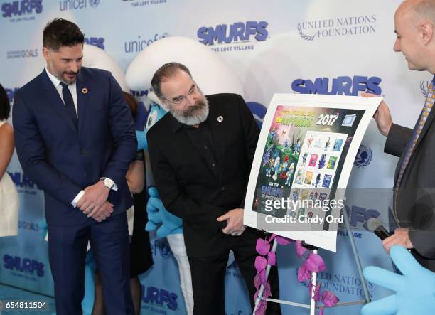 Actors Joe Manganiello and Mandy Patinkin view the Smurf stamp designs that will be available at the UN Post office as they are presented by UN OCSS...