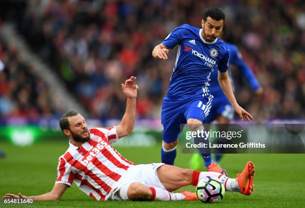 Erik Pieters of Stoke City tackles Pedro of Chelsea during the Premier League match between Stoke City and Chelsea at Bet365 Stadium on March 18,...