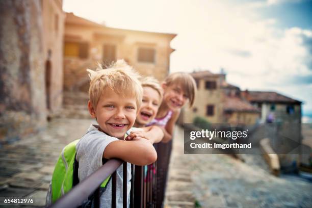 kinder von touristen, die schöne italienische stadt in der toskana - italien familie stock-fotos und bilder