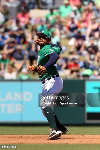 Dixon Machado of the Tigers throws the ball across the field during the spring training game between the New York Yankees and the Detroit Tigers on...
