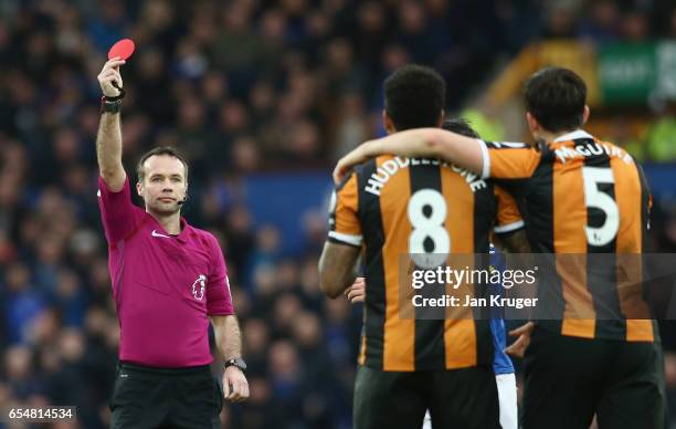 Referee Paul Tierney shows a red card to Tom Huddlestone of Hull City as he is sent off during the Premier League match between Everton and Hull City...