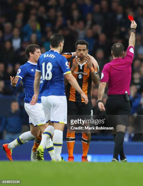 Referee Paul Tierney shows a red card to Tom Huddlestone of Hull City as he is sent off during the Premier League match between Everton and Hull City...