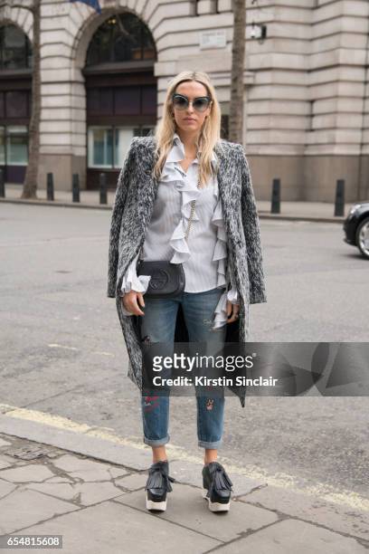 Fashion blogger Camila Carril wears a Haizhen Wang coat, Levi's jeans, Paloma Barcelo shoes, Fendi sunglasses, Sister Jane shirt and Gucci bag on day...