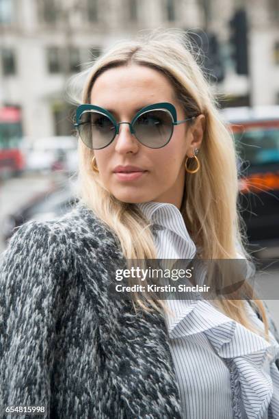 Fashion blogger Camila Carril wears a Haizhen Wang coat, Fendi sunglasses, Sister Jane shirt on day 5 of London Womens Fashion Week Autumn/Winter...