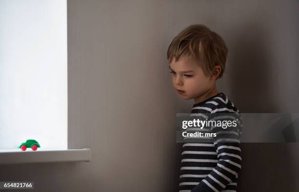 sad boy - autistic child stock pictures, royalty-free photos & images