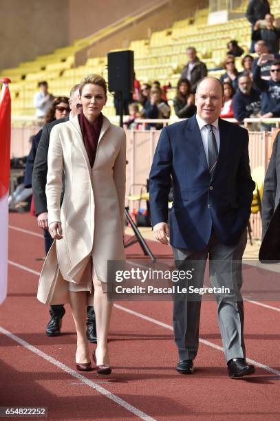 Princess Charlene of Monaco and Prince Albert II of Monaco arrive at the Sainte Devote Rugby Tournament on March 18, 2017 in Monte-Carlo, Monaco.