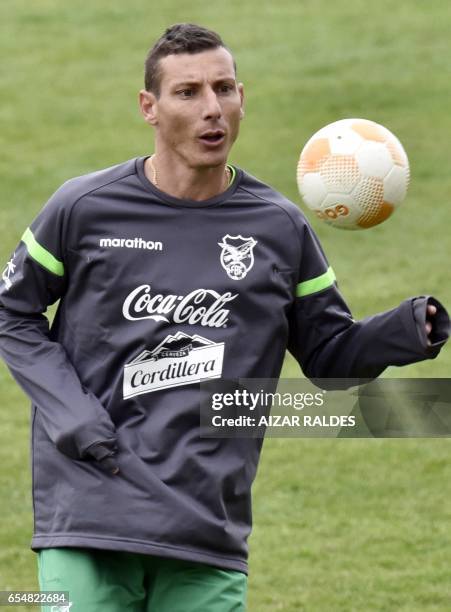 Bolivia's national football team player Pablo Escobar eyes the ball during a training session in La Paz on March 18, 2017 ahead of their South...