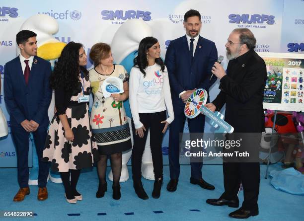 Actor Mandy Patinkin presents UN Young Sustainable Development Goals Advocates Karan Jerath, Noor Samee, and Sarina Divan with a key to Smur Village...