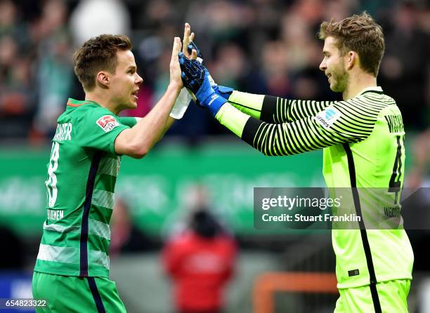 Niclas Moisander of Bremen celebrates with Felix Wiedwald of Bremen during the Bundesliga match between Werder Bremen and RB Leipzig at Weserstadion...