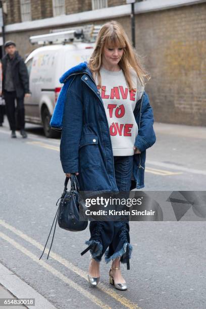 Senior print designer, Kelly Harrington wears a Ganni slave to love sweater, SJYP parka jacket, Balenciaga bag, By Mina with you shoes and Marques...