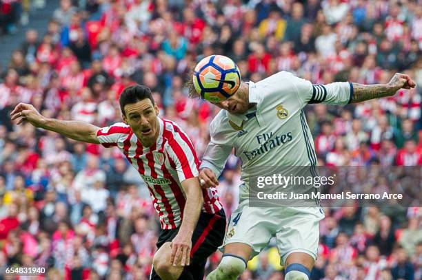 Sergio Ramos of Real Madrid competes for the ball with Aritz Aduriz of Athletic Club during the La Liga match between Athletic Club Bilbao and Real...