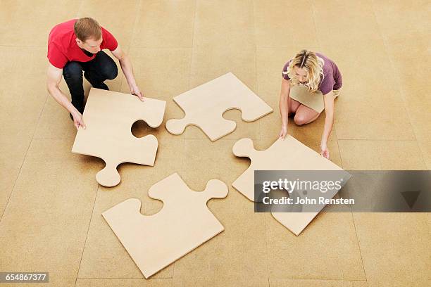 people doing puzzles with oversized props - holding prop stock pictures, royalty-free photos & images