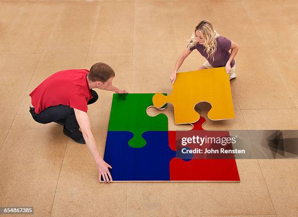 people doing puzzles with oversized props - part of something bigger stock pictures, royalty-free photos & images