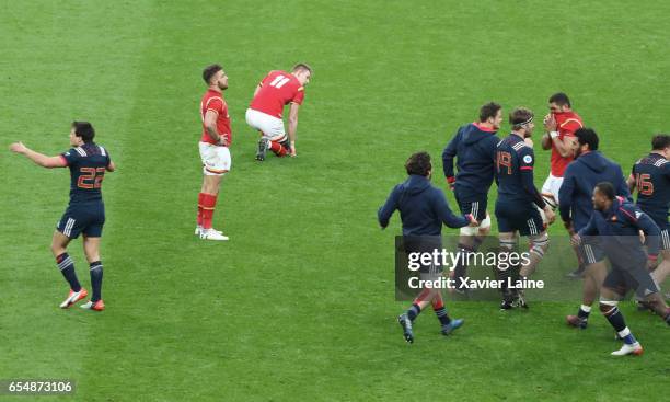 Players of France celebrate their victory as Wales players appear dejected after the RBS Six Nations match between France and Wales at Stade de...