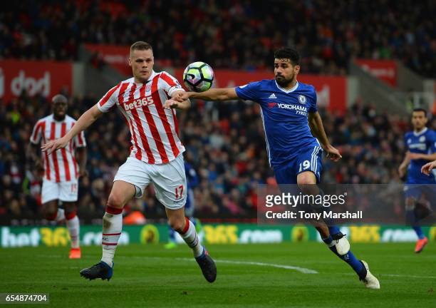 Ryan Shawcross of Stoke City is tackled by Diego Costa of Chelsea during the Premier League match between Stoke City and Chelsea at Bet365 Stadium on...