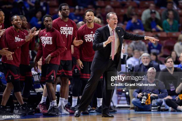 Head coach Phil Cunningham of Troy University yells to his players during the 2017 NCAA Photos via Getty Images Men's Basketball Tournament held at...