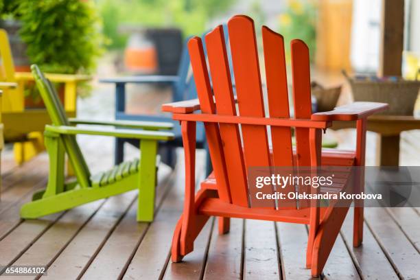 colorful muskoka chairs for people to relax in during the tour. - istock images stock pictures, royalty-free photos & images