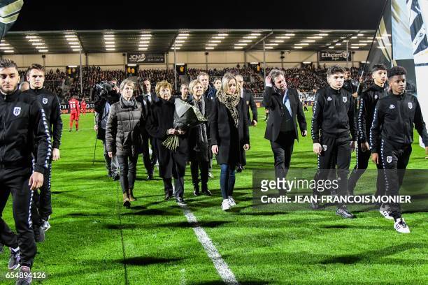 Kopa's family members arrive on the pitch for a tribute in honour of French football player Raymond Kopa who died on March 3 prior to the French L1...