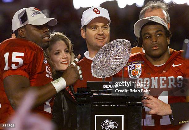 Head Coach Bob Stoops, J.T. Thatcher and Ontei Jones of the Oklahoma Sooners celebrate after defeating the Florida State Seminoles 13-2 to win the...