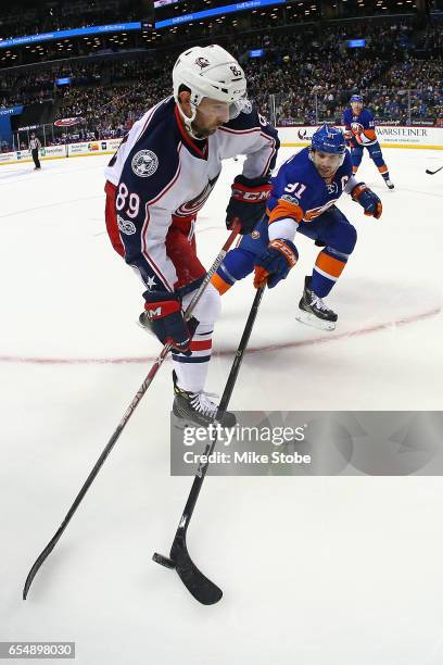 John Tavares of the New York Islanders and Sam Gagner of the Columbus Blue Jackets battle for the puck at the Barclays Center on March 18, 2017 in...