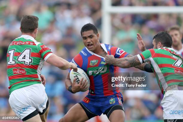 Peter Mata' Utia of the Knights is tackled by the Rabbitohs defence during the round three NRL match between the Newcastle Knights and the South...