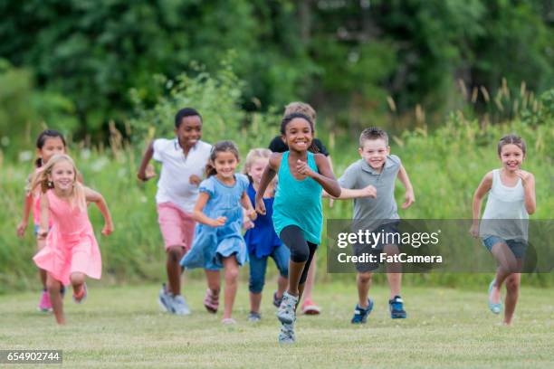 children running outside at recess - playing tag stock pictures, royalty-free photos & images