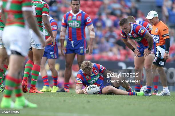 Nathan Ross of the Knights lies on the ground after getting injured during the round three NRL match between the Newcastle Knights and the South...