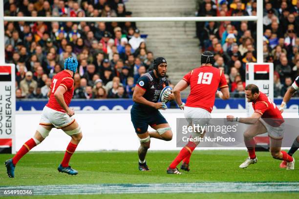France's prop Uini Atonio runs with the ball around Wales' Luke Charteris and Wales' flanker Justin Tipuric during the Six Nations tournament Rugby...
