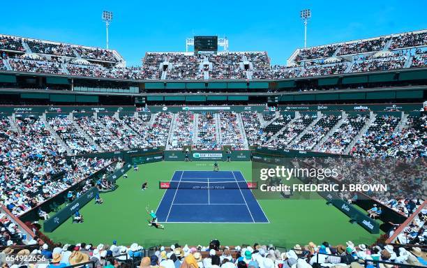 Roger Federer of Switzerland serves to Jack Sock of the US in their men's semifinal at the ATP Indian Wells Masters in Indian Wells, California on...