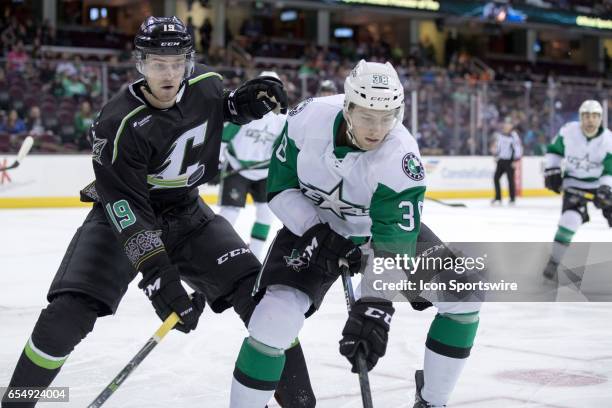 Texas Stars C Jason Dickinson plays the puck along the boards as Cleveland Monsters C Sam Vigneault defends during the second period of the AHL...