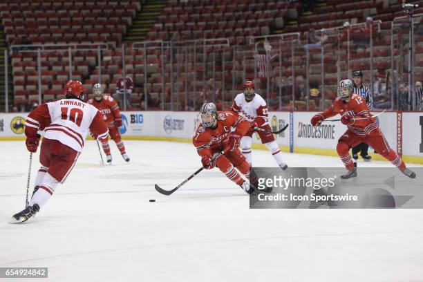 Ohio State Buckeyes forward Nick Schilkey skates with the puck during the first period of a Big 10 Men's Ice Hockey Tournament semifinal game between...