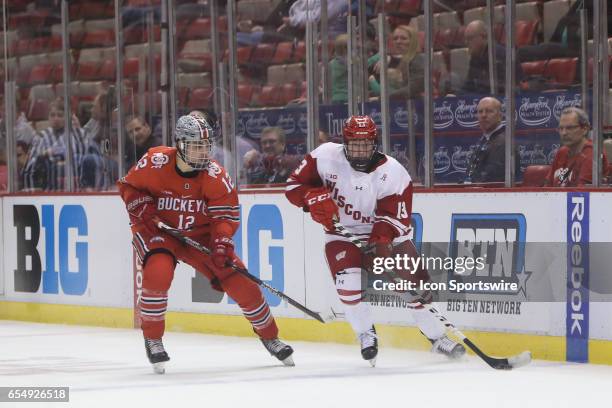 Wisconsin Badgers forward Ryan Wagner skates with the puck against Ohio State Buckeyes forward Miguel Fidler during the second period of a Big 10...