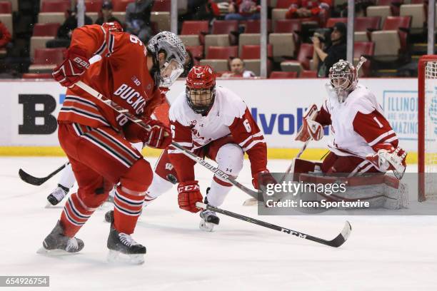 Wisconsin Badgers defenseman Peter Tischke plays defense against Ohio State Buckeyes forward Matthew Weis during the third period of a Big 10 Men's...