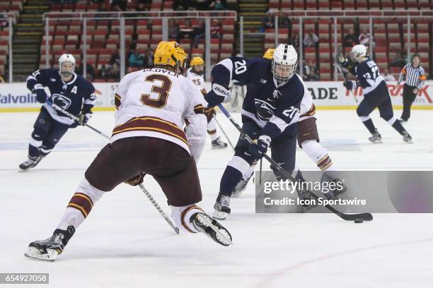 Penn State Nittany Lions defenseman Erik Autio fires a shot against Minnesota Golden Gophers defenseman Jack Glover during the third period of a Big...