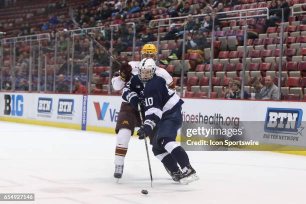 Penn State Nittany Lions forward Brandon Biro skates with the puck against Minnesota Golden Gophers defenseman Jack Sadek during the third period of...