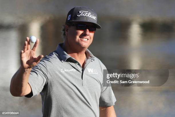 Charley Hoffman of the United States reacts after putting for birdie on the 18th green during the third round of the Arnold Palmer Invitational...