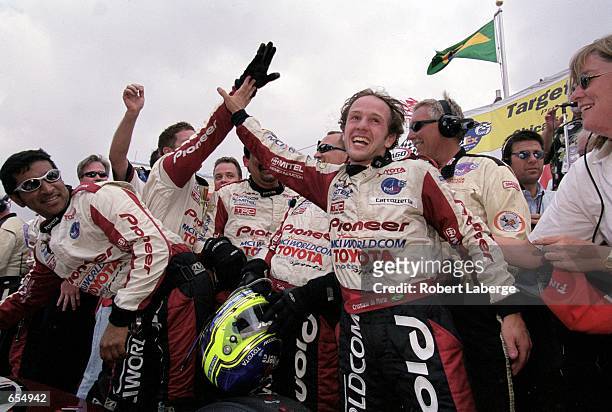 Driver Cristiano da Matta of Brazil who drives a Toyota Reynard 2KI for PPI Motorsports celebrates with his pit crew after winning the Target Grand...
