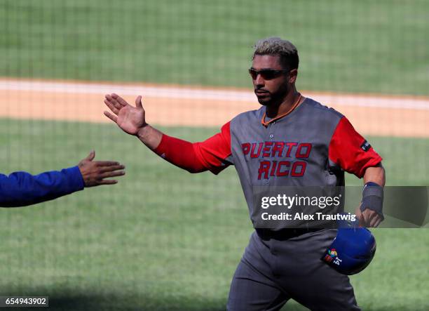 Mike Aviles of Team Puerto Rico is congratulate by teammates after scoring in the top of the seventh inning of Game 5 of Pool F of the 2017 World...