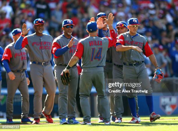 Mike Aviles Team Puerto Rico celebrates with teammates after winning Game 5 of Pool F of the 2017 World Baseball Classic against Team Venezuela on...