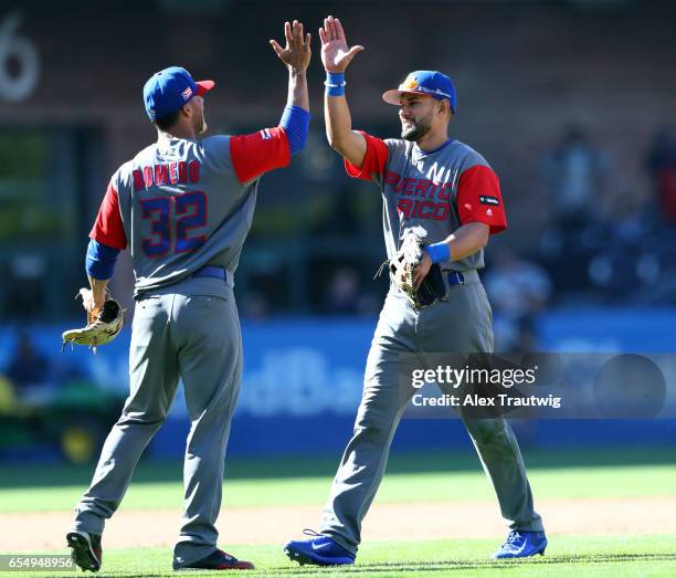Juan Carlos Romero, of Team Puerto Rico celebrates with Reymond Fuentes after winning Game 5 of Pool F of the 2017 World Baseball Classic against...