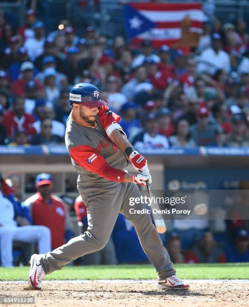 Mike Aviles of Puerto Rico hits an RBI single during the seventh inning of the World Baseball Classic Pool F Game Five between Puerto Rico and...