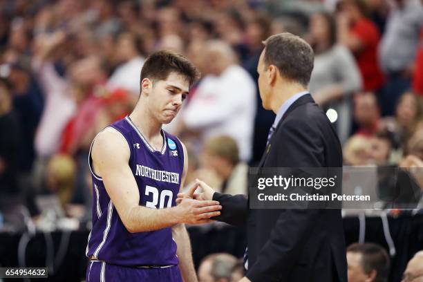 Bryant McIntosh and head coach Chris Collins of the Northwestern Wildcats shake hands as he is substituted out late in the game in their loss to the...