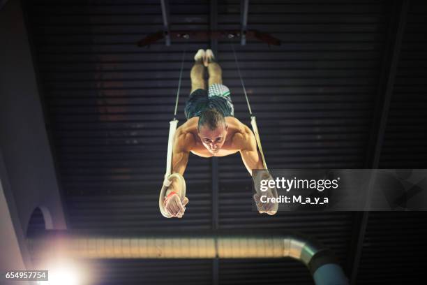 gymnastic ring training - male gymnast stock pictures, royalty-free photos & images