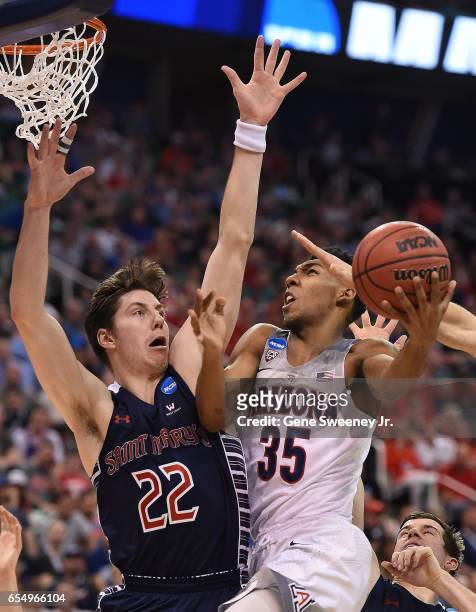 Allonzo Trier of the Arizona Wildcats attempts a layup defended by Dane Pineau of the St. Mary's Gaels during the second round of the 2017 NCAA Men's...
