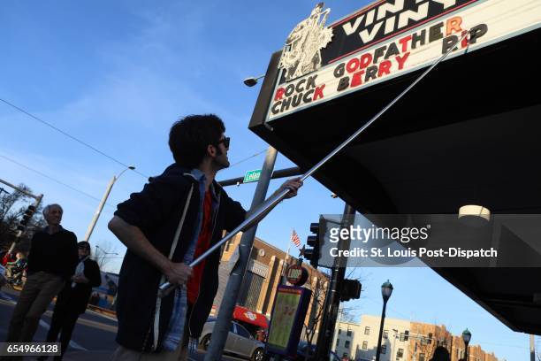 Teddy Kogos of Vintage Vinyl changes the sign at the famed record store on the Delmar Loop in St. Louis to mark the death of music legend Chuck Berry...