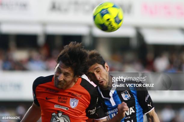 Juan Forlin of Queretaro jumps for the ball with Omar Gonzalez of Pachuca during their Mexican Clausura 2017 Tournament football match at La...